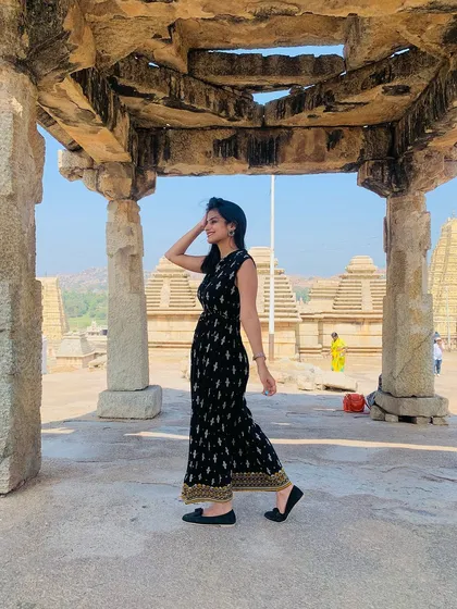 Walking through the stone mandapa of a temple in Hampi.