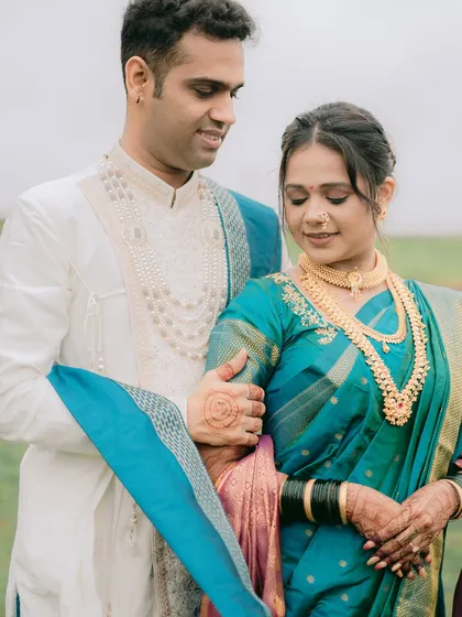 A quiet, intimate moment where the couple is lost in their own world. The groom's gentle touch and their soft expressions make this a very romantic shot.