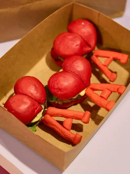 Heart-shaped red sliders with "A" shaped crisps, designed for a brand activation. This is how we incorporate logos and themes into fun, bite-sized snacks.