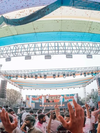The scale of a festival party is something else. This wide-angle shot from a Holi event shows the massive stage production and the sea of people united by color and music.