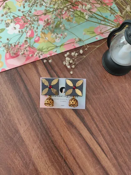 My gotapatti earrings are a festive favorite. These square fabric studs feature golden gotapatti work and a small jhumki drop, available in brown, green, and grey.