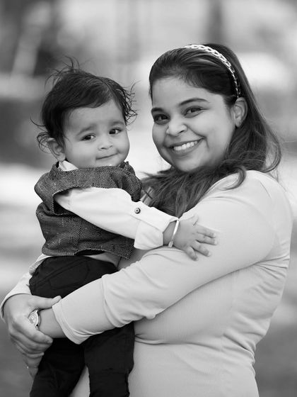 A slightly different angle of a mother and her baby, capturing a warm smile and the secure feeling of a mother's embrace.