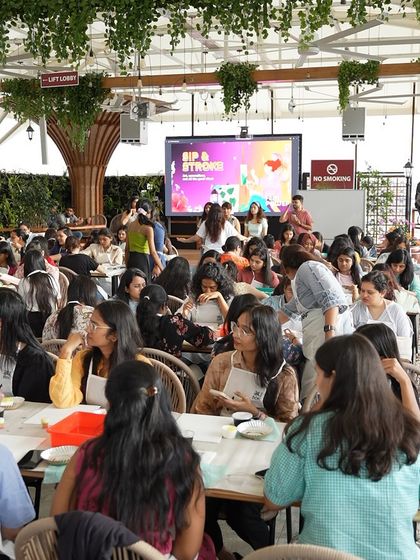 A wide shot of the texture painting workshop we conducted for 120 women at Meesho's office terrace. We can handle large-scale events seamlessly.