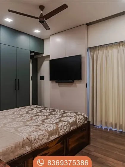 A full view of the highland green wardrobe in a bedroom setting. The deep color provides a beautiful, bold contrast to the warm wooden flooring and neutral walls.