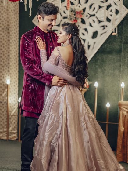 A beautiful pose that showcases the intricate details on the back of the bride's gown while maintaining a romantic connection between the couple.