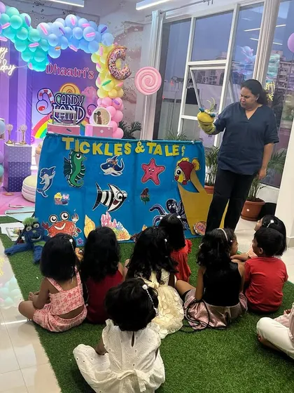 An 'Under the Sea' themed show at a birthday party. The colorful backdrop and puppets, like the crab and seahorse, create an immersive experience for the little ones.