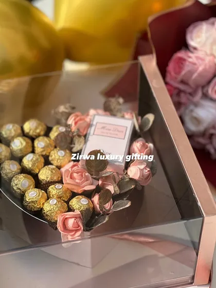 Celebrate love with elegance. This newly launched Valentine's hamper features a heart-shaped box of Ferrero Rocher and a Miss Dior perfume, all in a clear acrylic case.