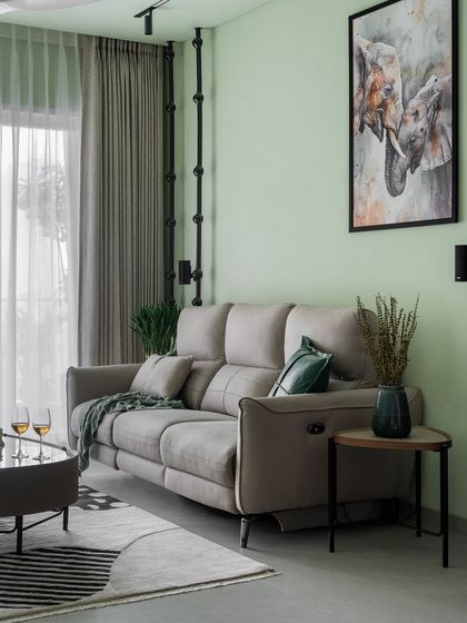 We used a soft, pastel green on the walls of this living room to create a calm and refreshing atmosphere. The sleek, modern recliner sofa ensures the space is as comfortable as it is beautiful.