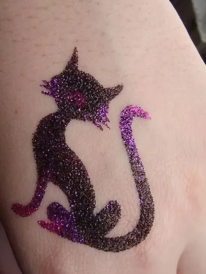 A sly cat silhouette created with black and purple glitter. This is a fun and stylish design for any animal lover.