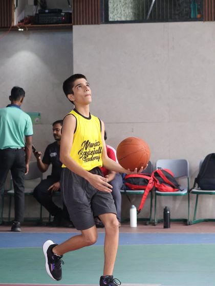 A player looks up after a shot, tracking the ball's path. We teach the importance of follow-through and focus in every aspect of the game.