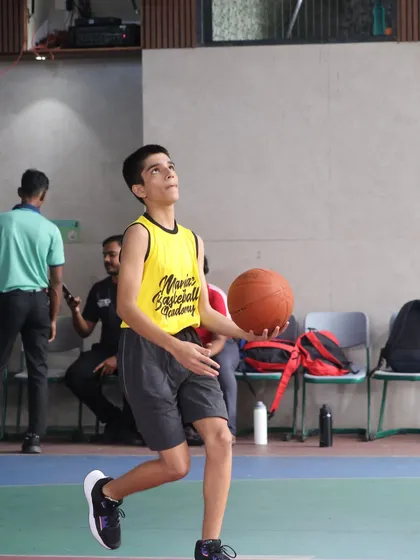 A player looks up after a shot, tracking the ball's path. We teach the importance of follow-through and focus in every aspect of the game.