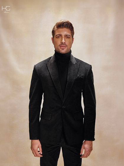 A straight-on portrait in the corduroy suit, showing how the monochrome look creates a powerful and sophisticated statement.