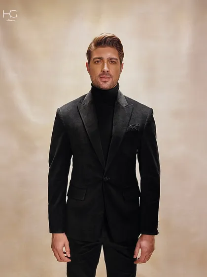 A straight-on portrait in the corduroy suit, showing how the monochrome look creates a powerful and sophisticated statement.