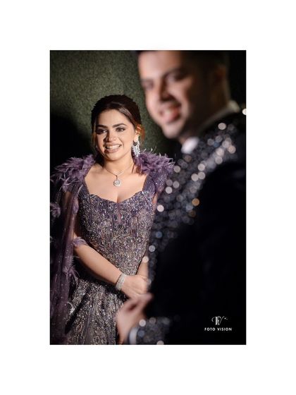 A candid shot of the bride looking towards the groom, her smile radiant, capturing a spontaneous moment of joy during their reception.