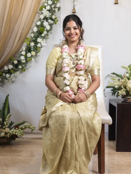 Shriya looking peaceful and happy during her baby shower ceremony. The focus was on clean, glowing skin.