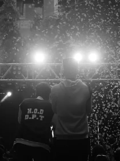 A black and white photo capturing the view from the stage during a confetti drop, showing the scale of the event.