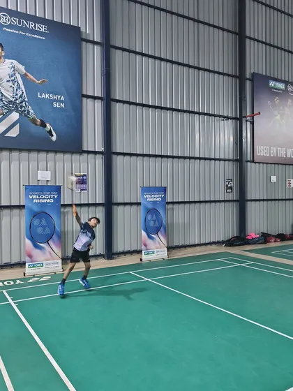 A wide shot of a player executing a powerful smash during the Yonex Demo Day. My spacious, well-lit courts are perfect for hosting such engaging community events.