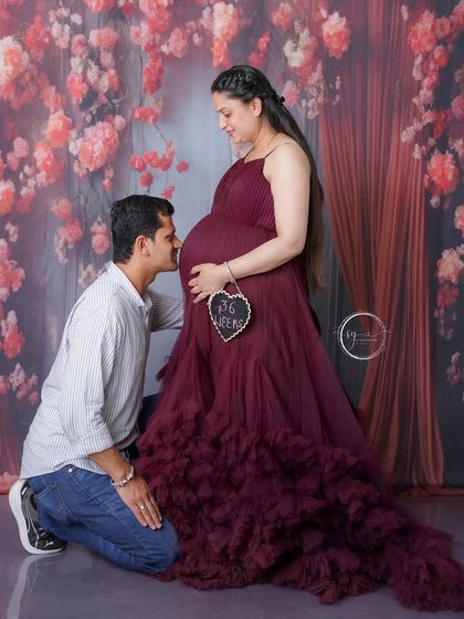 A father-to-be lovingly talks to the baby bump. This is one of the most heartwarming moments to capture during a couple's maternity session.