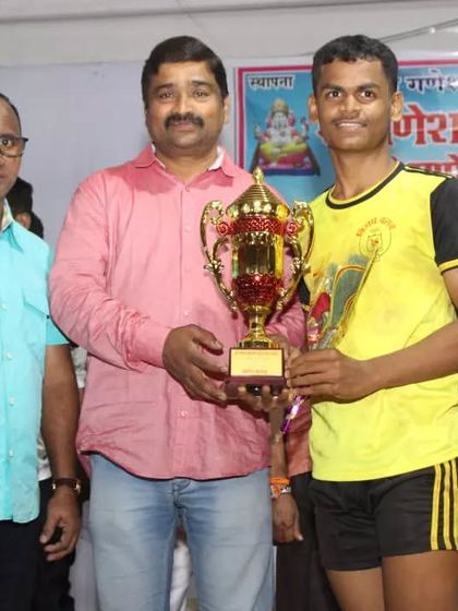 The captain of the sub-junior team receiving the winner's trophy.