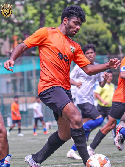 A player showing determination to get to the ball first, with the referee keeping a close watch.