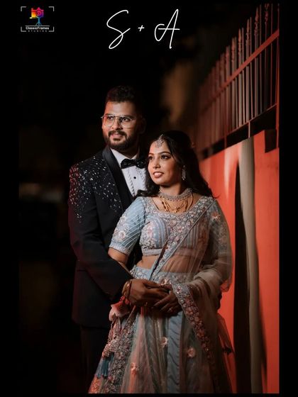 A stylish couple portrait taken at night. The dramatic lighting and the couple's modern reception outfits create a chic and memorable image.