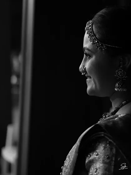 Sometimes, a moment's quiet grace is best captured in classic black and white. This timeless bridal portrait focuses on the bride's serene expression, highlighting her elegance and the beauty of the moment before the ceremonies begin.