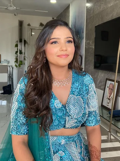 Mansi looking radiant and happy. The makeup is designed to enhance her natural beauty and give her a fresh, dewy glow.