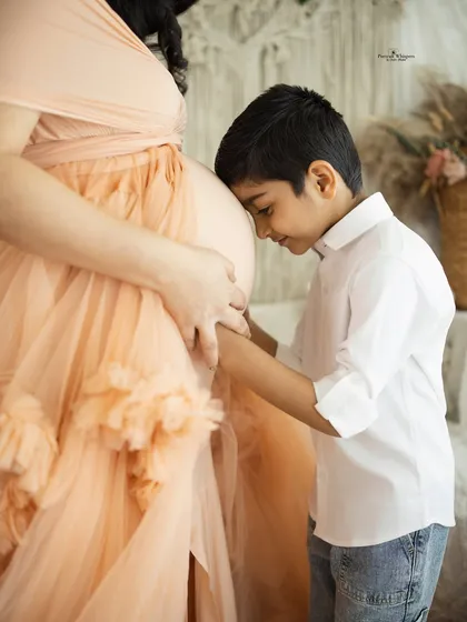 The sweetest moments are often the unscripted ones. Capturing the tender connection between a big brother and his soon-to-arrive sibling is what makes family photography so special.