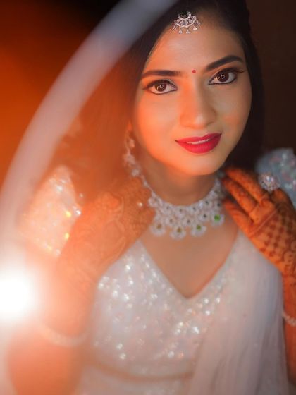 A beautiful portrait of Rakshita, her eyes and smile shining bright. The soft veil adds a touch of romance to the look.