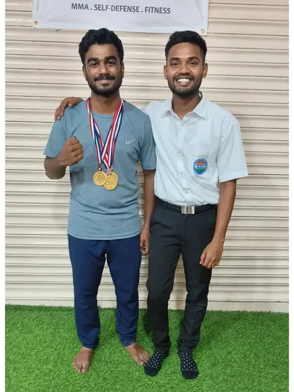 A proud moment between a student and his coach, who also served as a referee at the event. We are involved in every aspect of our students' journey.