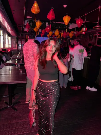 A posed shot in the same bar, showing off my outfit for a night out.