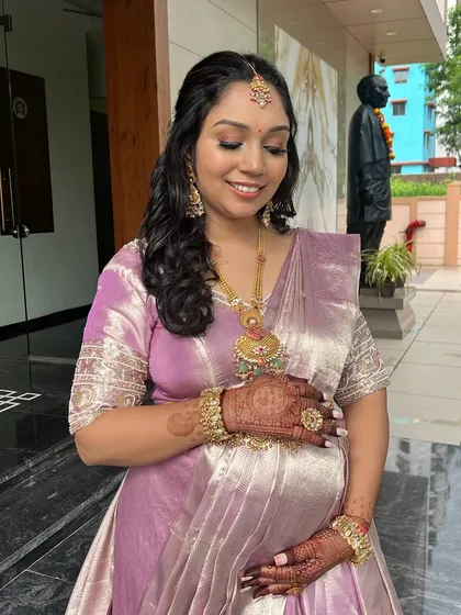 A heartwarming shot of the mom-to-be cradling her bump, looking absolutely radiant.