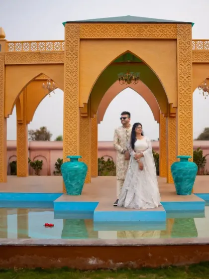 A beautiful moment of togetherness. This couple's pre-wedding shoot is made even more special with our elegant white lehenga and matching sherwani.