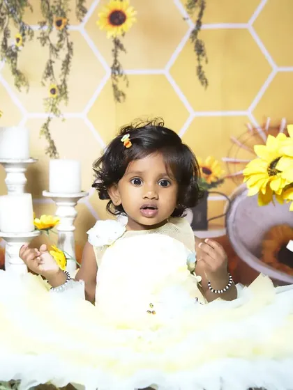 A bright and cheerful sunflower themed session. The vibrant yellow dress and a backdrop of sunflowers create a warm, happy atmosphere for capturing your child's sunny personality.