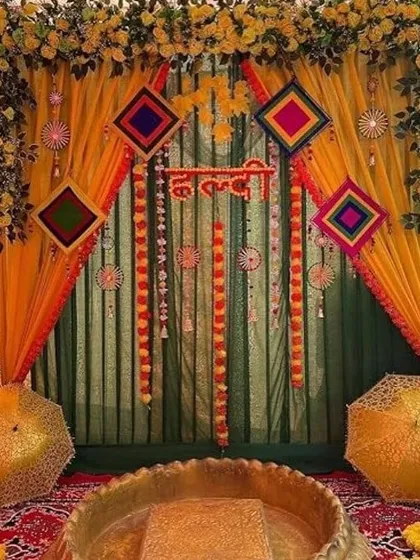A very traditional and colorful Haldi setup. We used layers of yellow and green curtains, decorated with marigold strings and colorful Rajasthani-style hangings, creating a rich and festive atmosphere.
