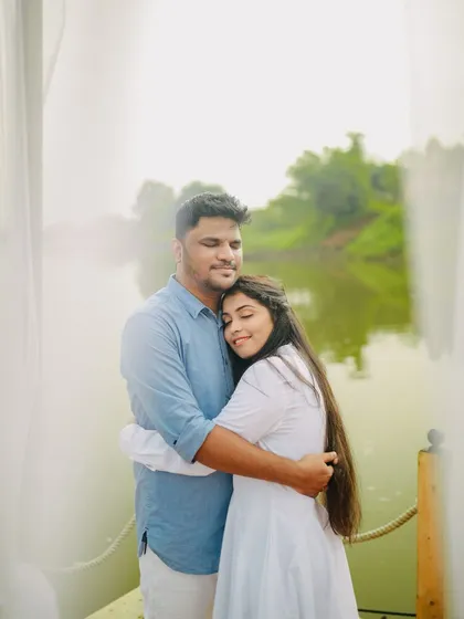 A heartfelt embrace after the 'yes'. This close-up shot captures the emotion and love of the moment, with the beautiful lake in the background.