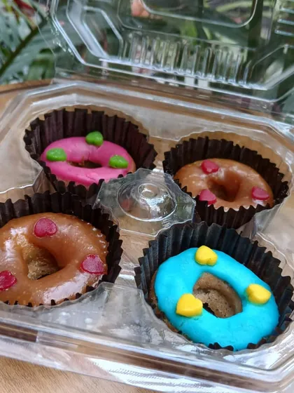 Look at these colorful, freshly baked donuts! I make these with pet-safe icing and natural ingredients like apple, pumpkin, and peanut butter. They are a perfect little treat to make any day feel like a celebration.