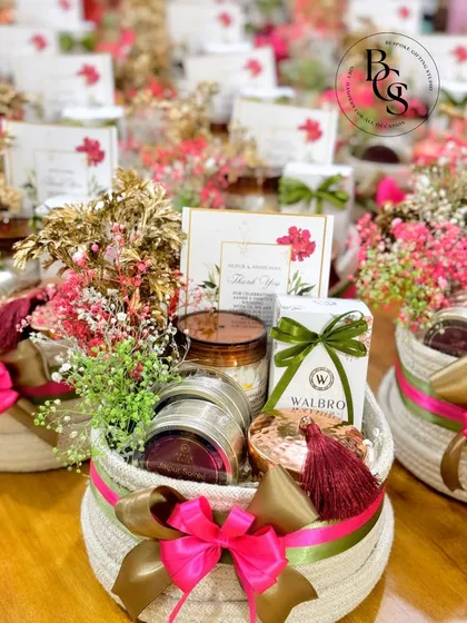 Another example of a beautiful in-room hamper for a wedding. The combination of pink and gold ribbons with fresh baby's breath creates a romantic and celebratory feel, perfect for welcoming guests to your special event.