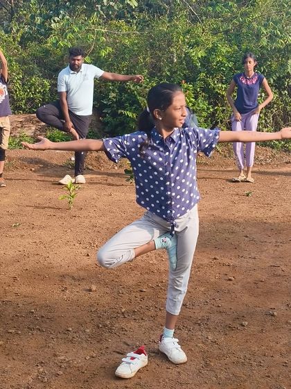 Campers start their day with yoga and stretching exercises at our Barapole camp, connecting with nature and preparing for the day's adventures.