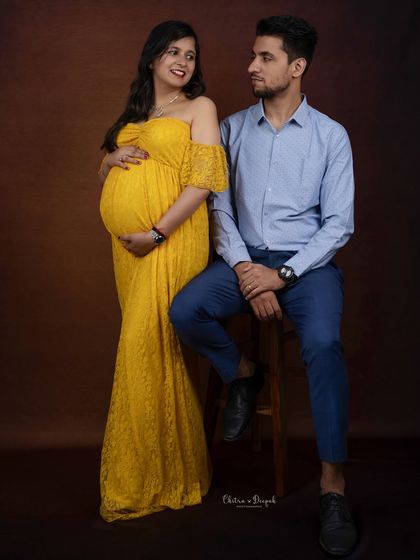 A relaxed and happy portrait of the couple. Her bright yellow dress and their easy smiles create a warm and joyful atmosphere.