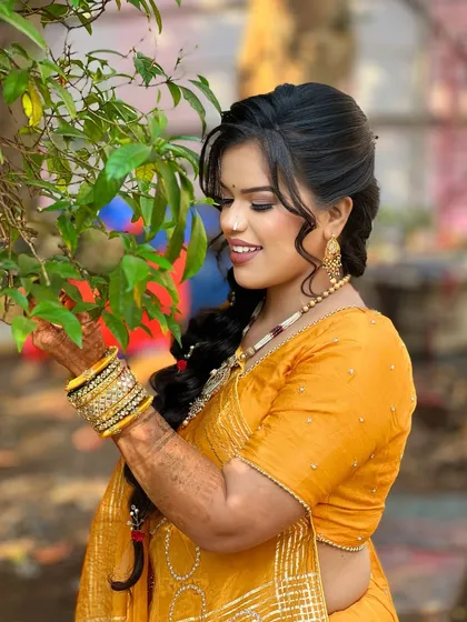 A candid moment of the bride, her smile as bright as her outfit.