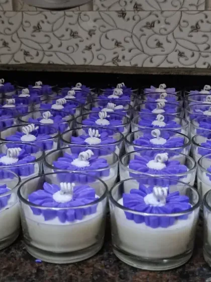 An entire batch of purple flower jar candles lined up, ready for the next step in production. This shows my organized approach to fulfilling large orders.