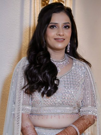 Urvashi looking absolutely radiant for her engagement. We chose a soft glam look with open waves that felt both modern and timeless, letting her happy smile be the main focus.