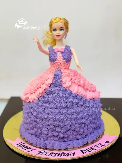 A classic Barbie doll cake with a beautiful gown made of purple and pink frosting. This standing doll cake is a timeless choice for a princess-themed birthday party.