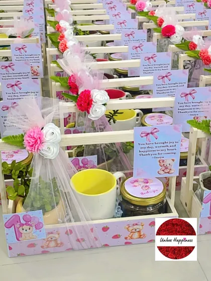 A beautiful arrangement of pink teddy bear return gifts, perfect for a little girl's first birthday.