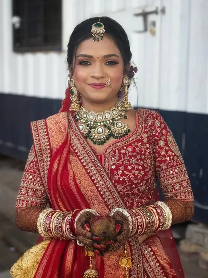 The bride holding a coconut, a traditional element in many Indian weddings, looking absolutely beautiful.