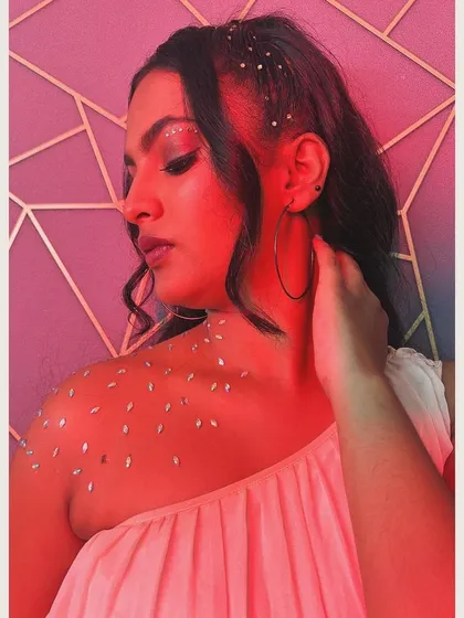 The same look under a dramatic pink light, showing how the glitter and gems catch the light for a stunning, magical effect.