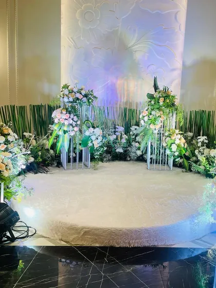Another angle of the white engagement stage, showing the detail in the floral arrangements and the clean, modern aesthetic of the design.