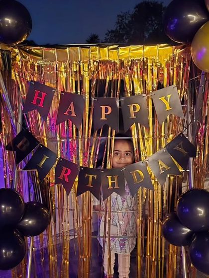 A simple yet fun photo corner on the terrace using a gold foil curtain and a "Happy Birthday" banner.
