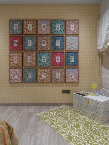 In this bedroom, I created a unique art installation using framed postcards from the New York Botanical Garden. Set against a soft printed wallpaper, this cost-effective solution adds immense personality, charm, and a touch of nostalgia to the room.